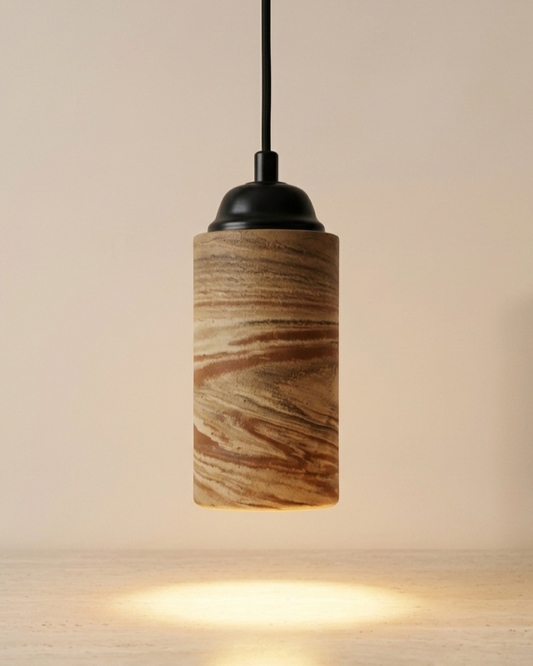 Studio front view of the Lumen cylindrical ceramic pendant light showing its marbled clay pattern
