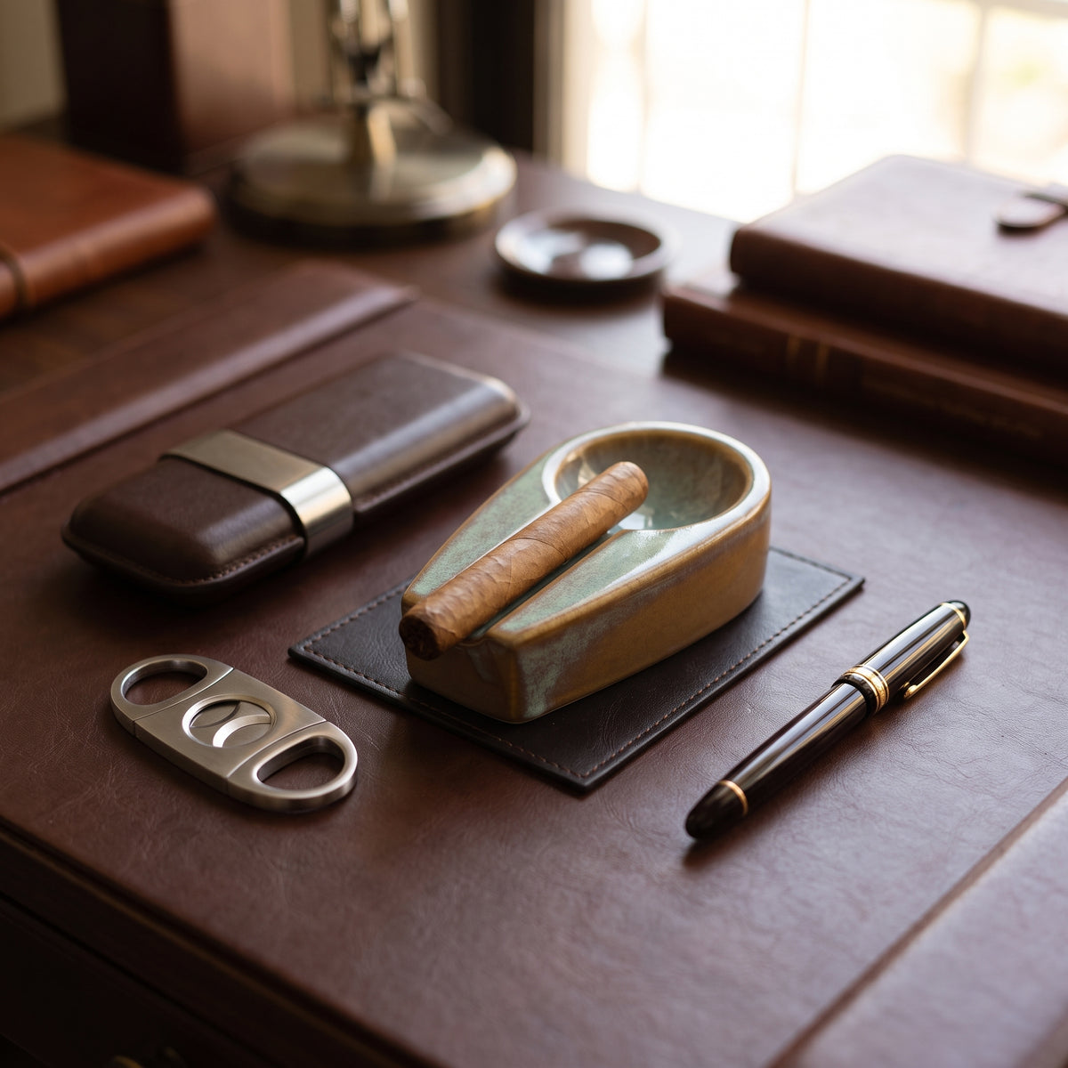 Executive office desk setup featuring a ceramic cigar ashtray, leather wallet, and pen